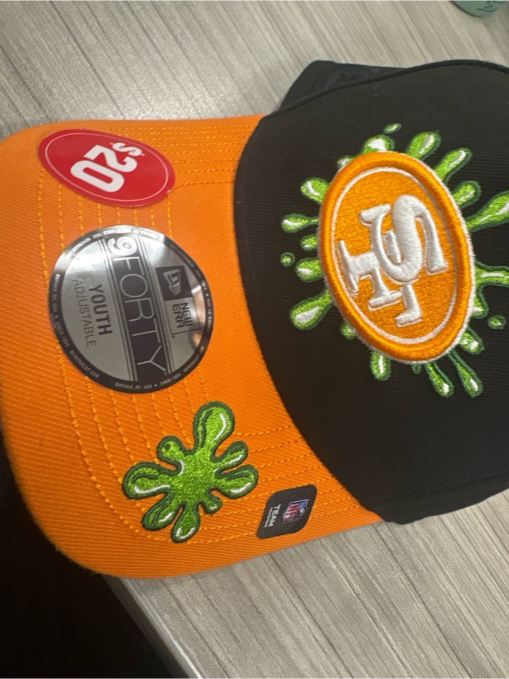 New Era Kids Orange and Black Baseball Cap with Green Embroidery